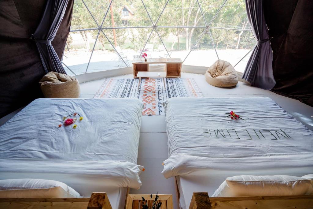 Giường trong phòng chung tại Bai Tu Long Mountain Resort