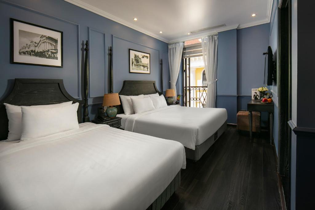 Giường trong phòng chung tại The Exquisite HaLong Hotel