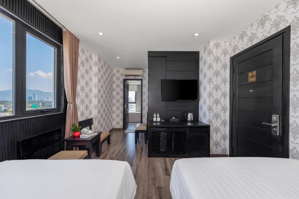 Giường trong phòng chung tại Ocean Star Da Nang Bay Hotel